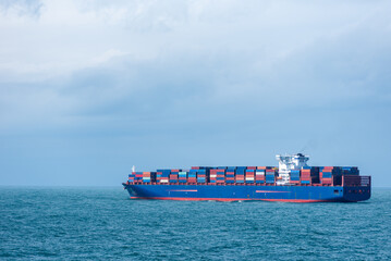 Large container ship sailing through the Atlantic Ocean, near US coast. She is fully loaded with...
