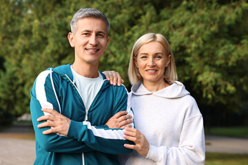 Portrait of happy couple in sportswear outdoors