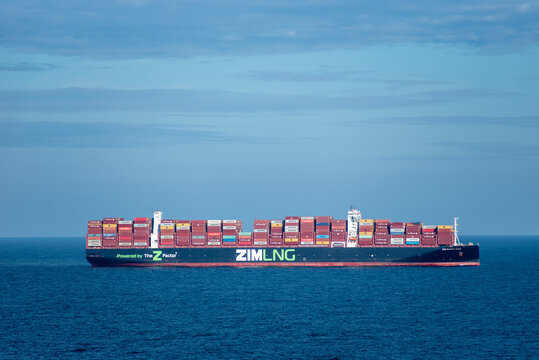 At sea, Atlantic Ocean - Large container ship ZIM SAMMY OFER owned by ZIM sailing through the Atlantic Ocean, near US coast. She is fully loaded with colorful containers.