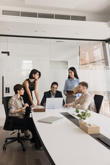 Business team of diverse colleagues and Indian boss meeting at large table, discussing online...