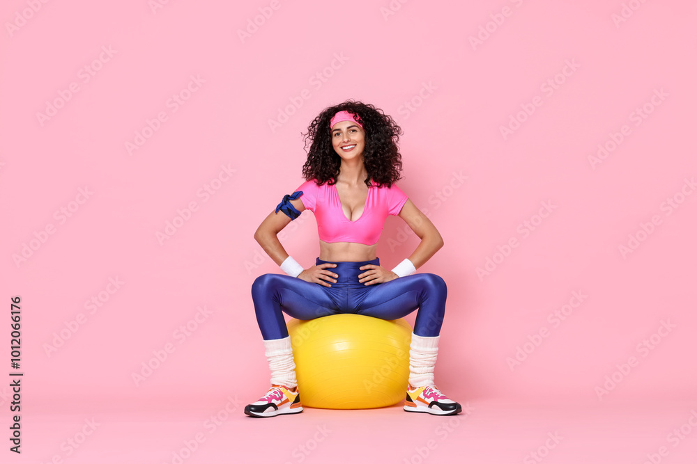 Wall mural Aerobics. Happy woman with fitness ball on pink background