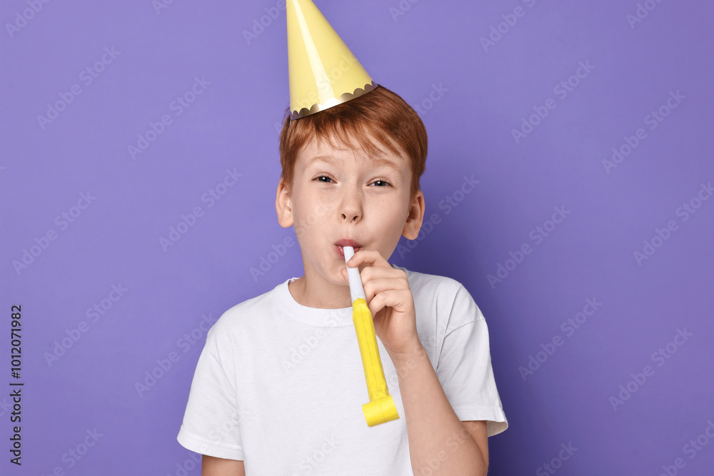 Poster Little boy in party hat with blower on purple background