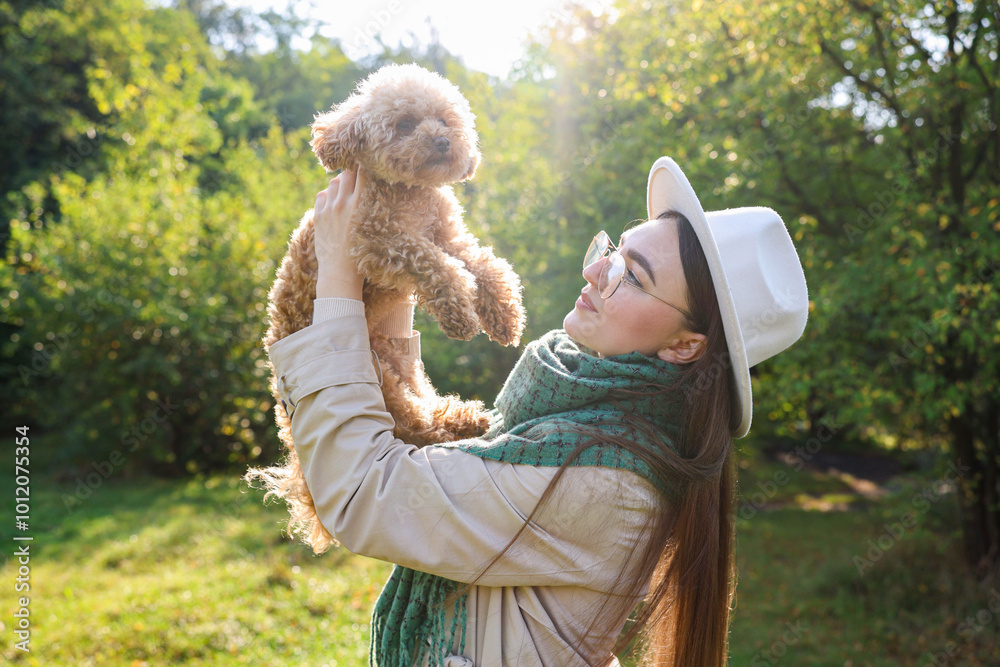 Sticker Woman with cute dog in autumn park on sunny day