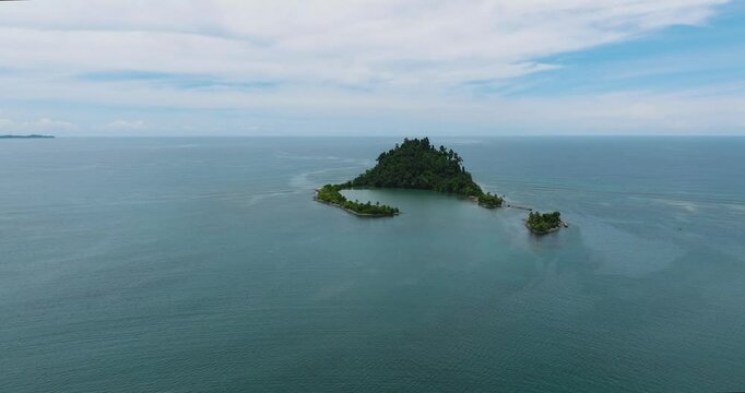 Beautiful Cabugao Island in letter C formation with green trees. Mindanao, Philippines.Travel and summer concept.