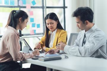 Collaborative Brainstorm: A diverse team of professionals engages in a focused discussion, their attentive expressions and shared documents reflecting a collaborative approach to problem-solving.