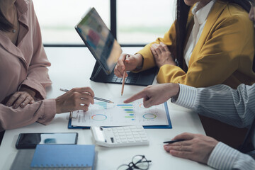 Strategic Collaboration: A close-up shot of a diverse business team collaborating on a project,...