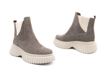 Pair of fashionable suede leather boots isolated on white background. View from all sides.	