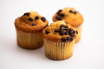 Closeup of three delicious milk chocolate chip mini muffins