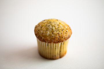 Lemon poppyseed muffin on white background