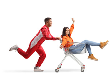 Car racer running and pushing a young woman inside a shopping cart