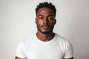 Fototapeta premium Minimal portrait of handsome black man posing in studio against white background, Generative AI