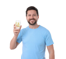 Happy man holding glass of water with lemon on white background