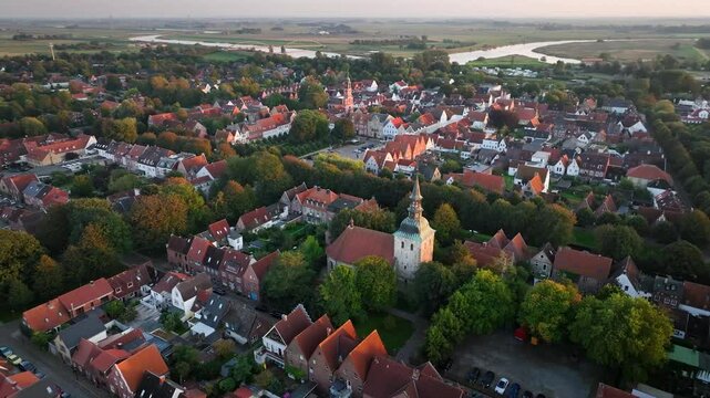 Aerial orbit of St. Christopher's Church in Friedrichstadt, a charming Dutch-style town in Schleswig-Holstein with romantic canals along the Eider and Treene rivers, framed by historic streets.