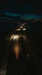 Obraz premium night road view from above from drone, cars driving on night road