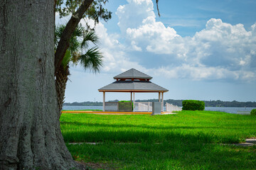 photo of a gazebo against the background of green grass, a lonely gazebo, sunny weather