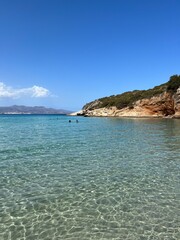 Crete, Greece - September 26, 2023: Beautiful colorful beach at Crete island, Greece. Voulisma paradise beach with rocks and mountains. Summer vacation travel holiday background concept.