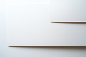 Fototapeta premium Photo of a Blank Business Card on a White Background from Top View, Ideal for Web Banner Design.