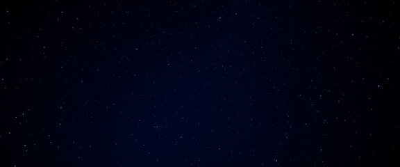 Starry sky background, blue night sky full of stars, glowing stars in the dark space, starry background, dark night, stars in the distance, starlight, dark background with a blue glow, night sky.	
