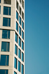 Front view of a white modern skyscraper perfect symmetry with blue sky and copy space. Architecture background concept