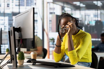 Tired programmer having strained eyesight from overworking, doing software quality assurance. Woman...