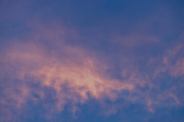 A beautiful sky tinted by the sun leaving vibrant shades of gold, pink, blue and multicolored. Clouds in the twilight evening and morning sky. Cloudy sky background in the evening, and during the day.