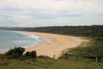 Haywards Beach at Wallaga Lake on the south coast of New South Wales, Australia. A beautiful sandy beach with surf waves.