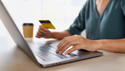 girl makes a purchase on the Internet on the computer with credit card
