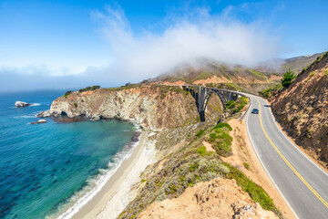 Beautiful scenery of Pacific Ocean coast along Highway 1 and Big Sur, wonderful aerial view of Bixby Bridge, sunset, sunrise, fog. Concept, travel, vacation, weekend