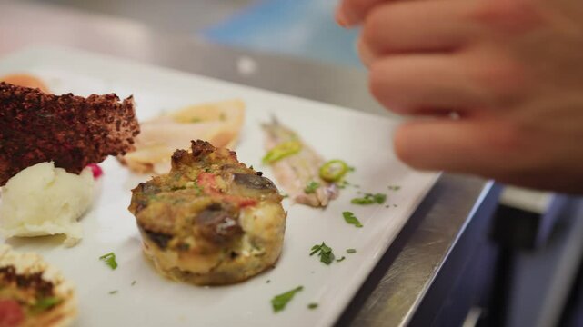 Plating Of A Raw And Cooked Fish Based Appetizer In A Luxury Italian Kitchen