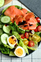 Fresh salad with cucumber, cherry tomatoes and salted salmon