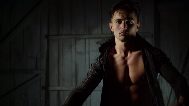 Sexy Topless guy undressed shirt. Young sexy man with muscular body takes off his shirt. Sexy male model. Seductive guy. Handsome shirtless man. Muscular male fit body. Male fashion model.