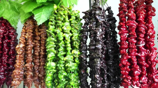 Traditional Churchkhela Hanging in Rows. Video of Georgian Sweet Made with Nuts and Grape Juice.