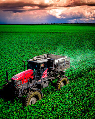 Agribusiness: Tractor throwing limestone over crops on the farm. © herbertmonfre