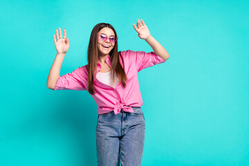 Photo portrait of lovely teen lady sunglass wave hands have fun dressed stylish pink garment isolated on cyan color background