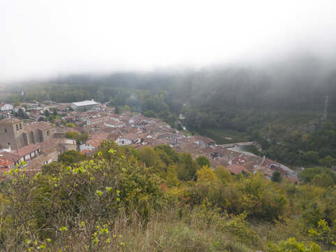 Bugui Navarra Spain, aerial view from viewpoint on a cold day with heavy fog. Small tourist village surrounded by mountains and forests.