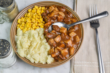 beef stew with  corn and buttered mash potatoes