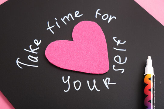 Naklejki inscription take time for yourself, text in white chalk marker on black board, motivation for the day, top view, close-up self love concept,