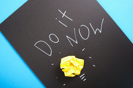 writing with white chalk marker on a black board do it now