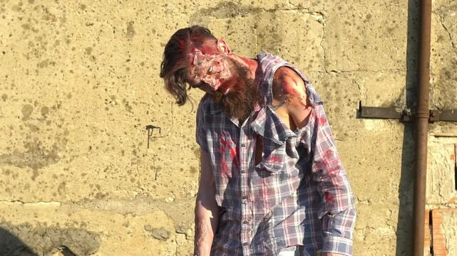 Halloween bearded man. Creepy man with bloody Halloween face. Man zombie with blood on face. Creative art make-up for Halloween. Man Scary zombie. Zombie male makeup for Halloween concept.