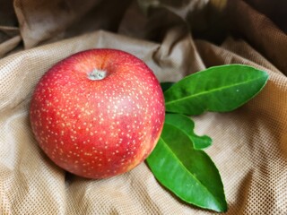 Ripe apple on brown background