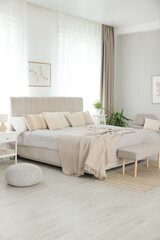 Big comfortable bed in room. Interior design