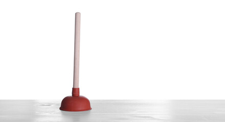 Plunger on white wooden table. Pipe cleaning tool