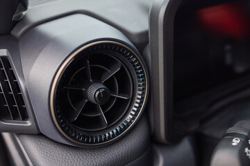 Closeup of car dashboard air vents near gear shift