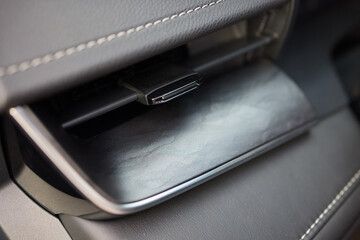 Closeup of car dashboard air vents near gear shift