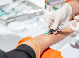 Close up doctor taking blood sampling.