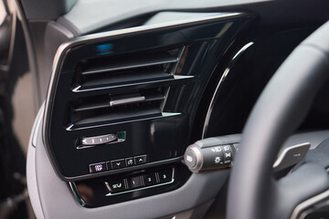 Closeup of car dashboard air vents near gear shift