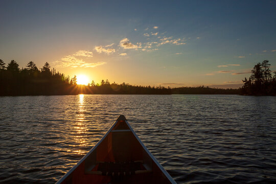 Canoe on a northern Minnesota boundary waters lake at sunset on an autumn evening