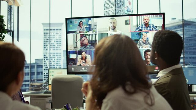 General manager starts a meeting on online videoconference call in the boardroom, discussing about updates with his staff. Business associates reviewing financial planning for growth. Camera B.