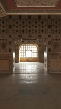 Details of an intricate walls interior of the famous tourist landmark Sheesh Mahal or Mirror Palace. Inside Amer Fort, Amer, Rajasthan, India