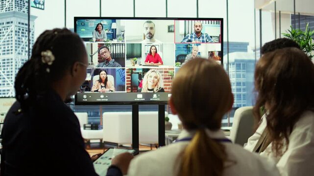 Marketing team analyzing big data insights on online videoconference with the advisory board, creating detailed infographics to present progress and goals. Remote presentation. Camera B.
